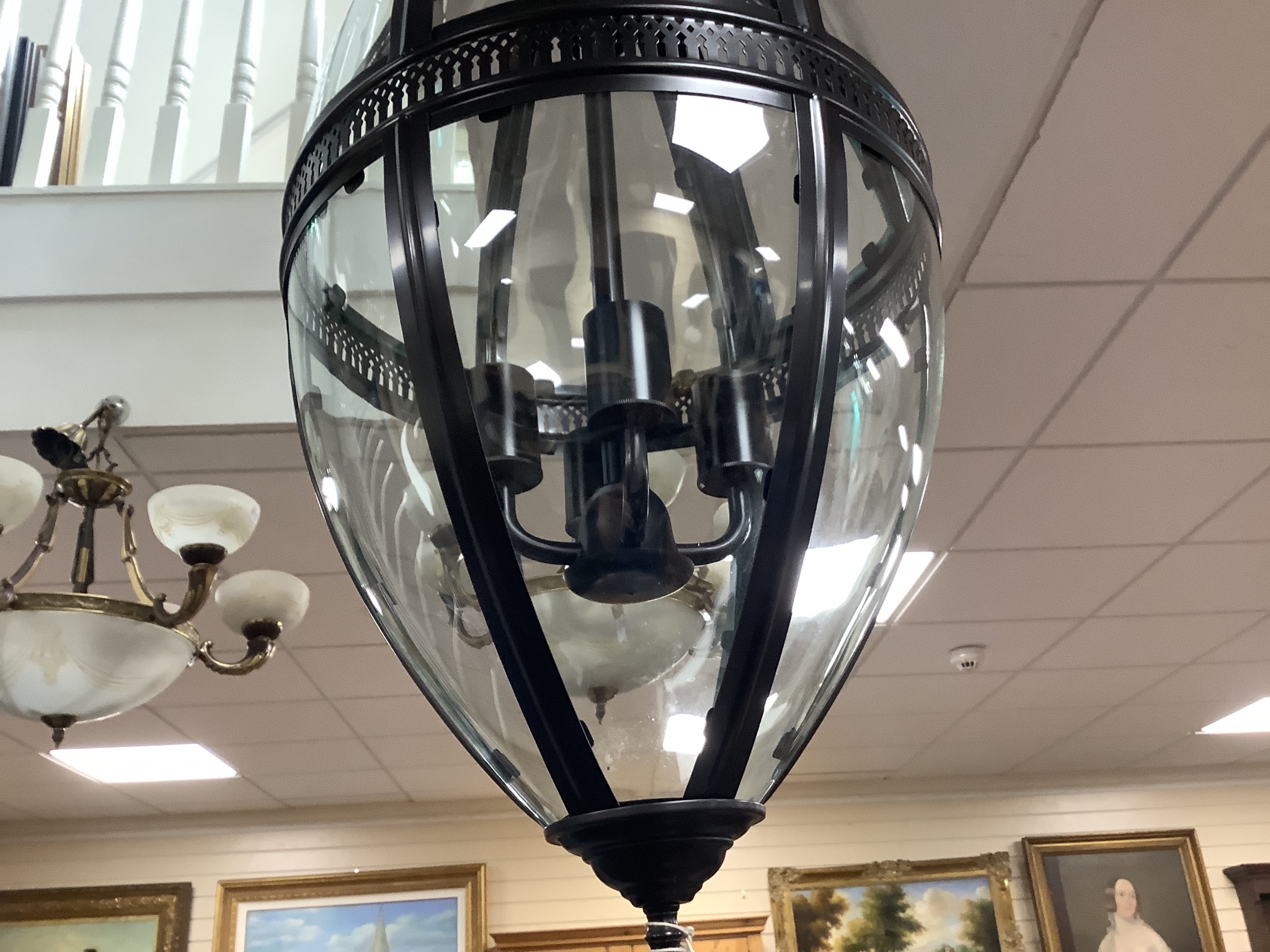 A contemporary black metal and glass hall lantern, height approx. 90cm
